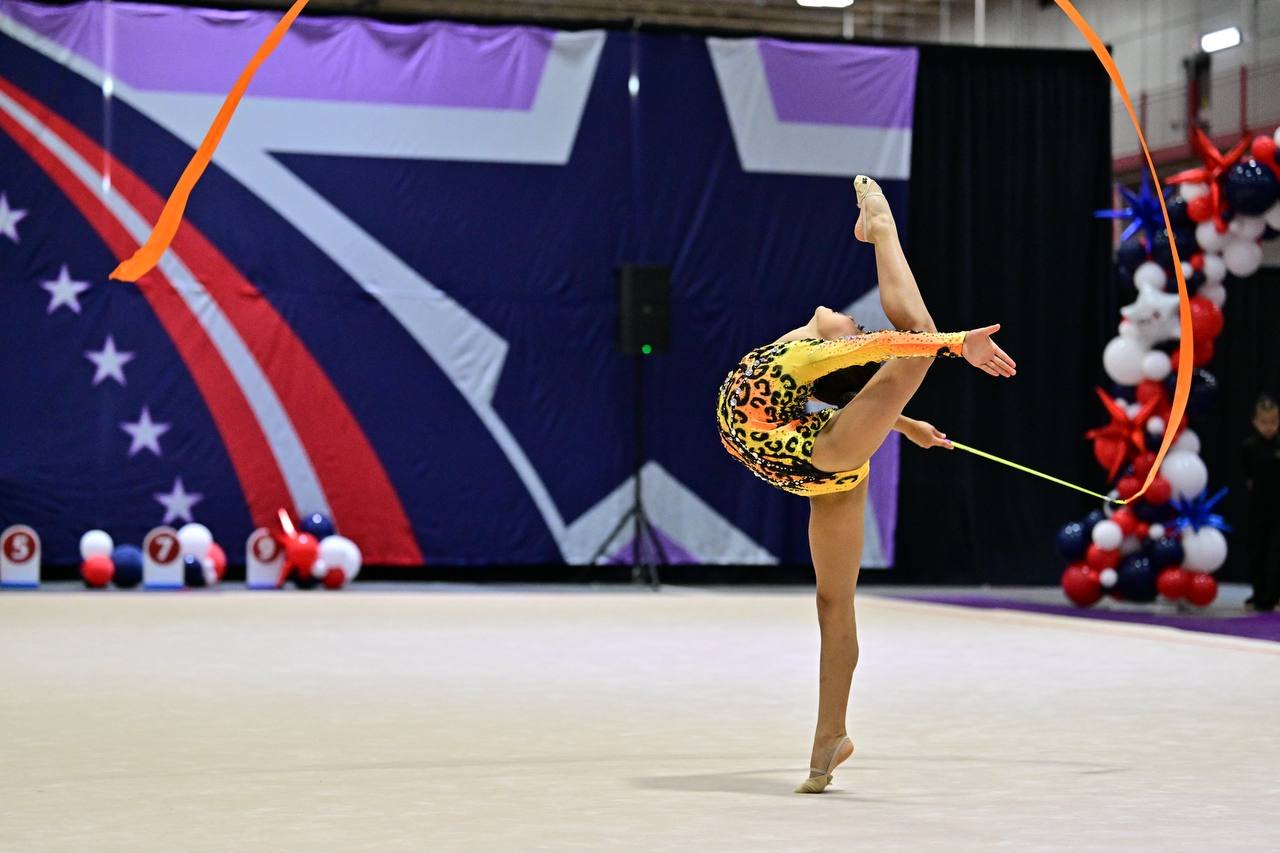 SRG athlete performing with ribbon at USA Gymnastics competition