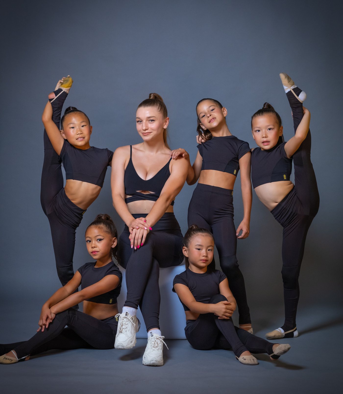 Coach Sofiia with the competitive team, studio portrait